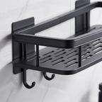 Close-up of the adhesive mounting plate and the removable side hooks on the black bathroom shelf