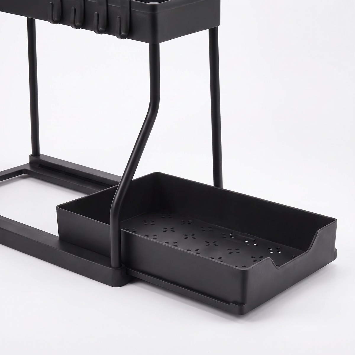 Close-up of the shallow slide-out bottom tray with drainage slots on the two-tier under-sink organizer