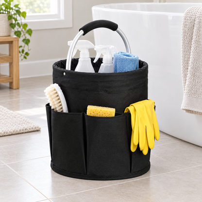 Black foldable cleaning caddy on a bathroom floor beside a bathtub, holding spray bottles, a brush, a sponge and rubber gloves