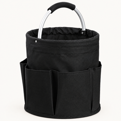 Empty black round fabric cleaning caddy with exterior pockets and an arched aluminum handle on a light background