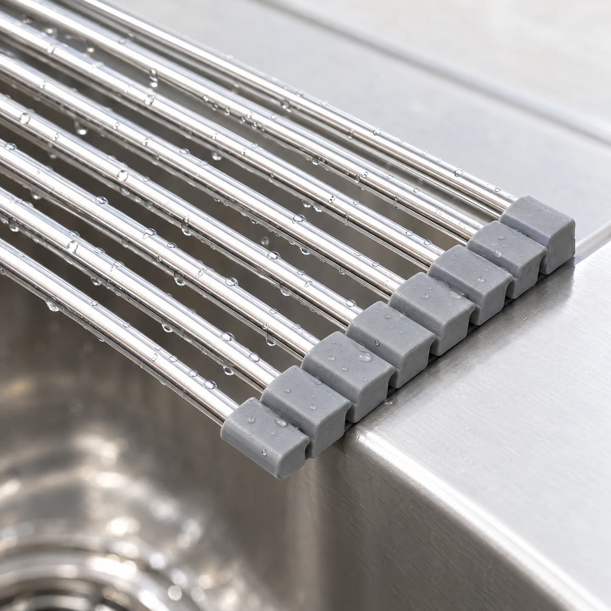 Close-up of the stainless-steel rods and grey end pieces resting on the edge of a sink