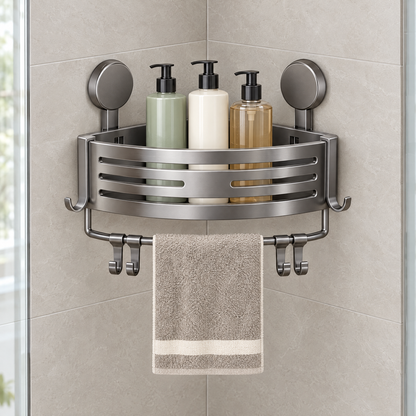Grey corner shower caddy with towel bar mounted with suction cups in a tiled shower corner holding bottles and a hand towel
