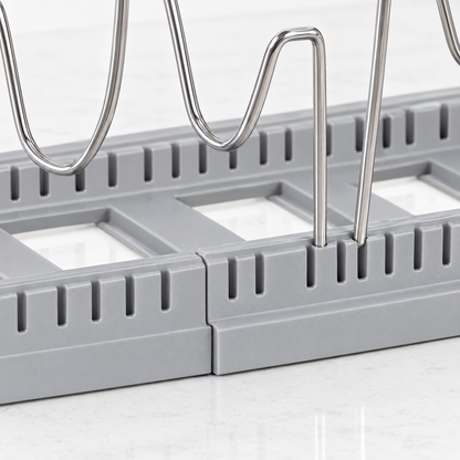 Close-up of the slotted base and adjustable wire dividers of the pot and pan organizer
