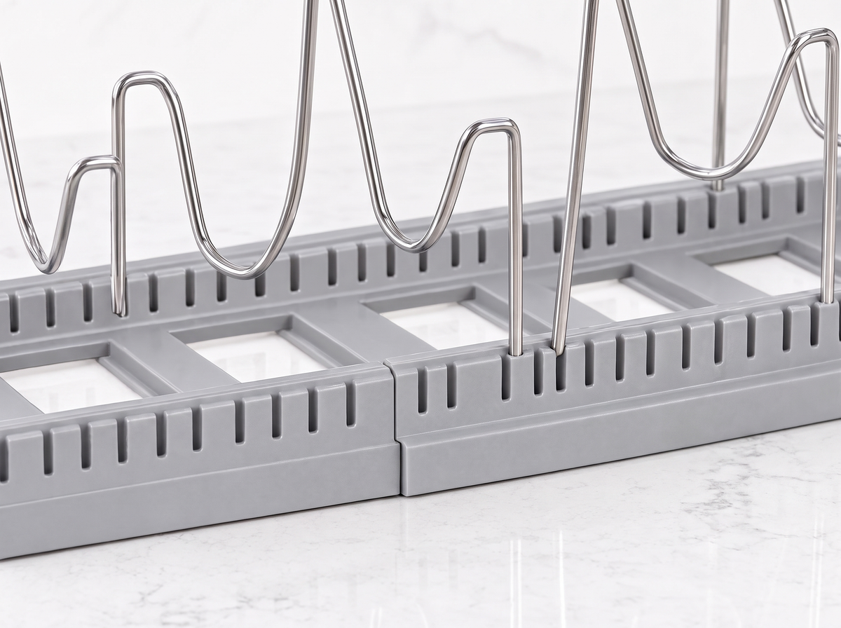 Close-up of the slotted base and adjustable wire dividers of the pot and pan organizer